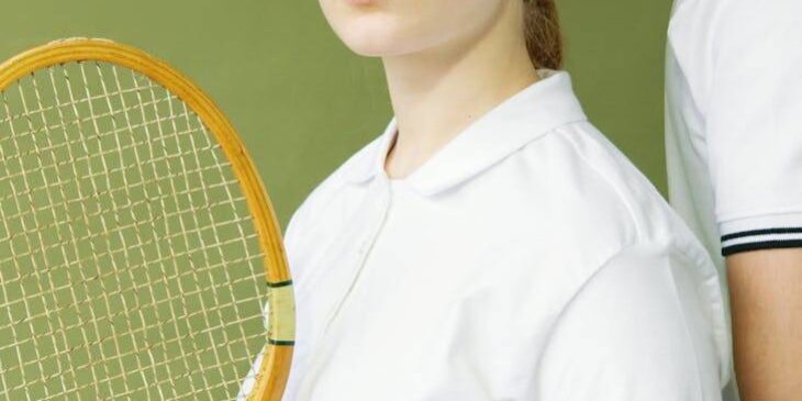 pexels-photo-7648364 a woman in white shirt holding a wooden racket